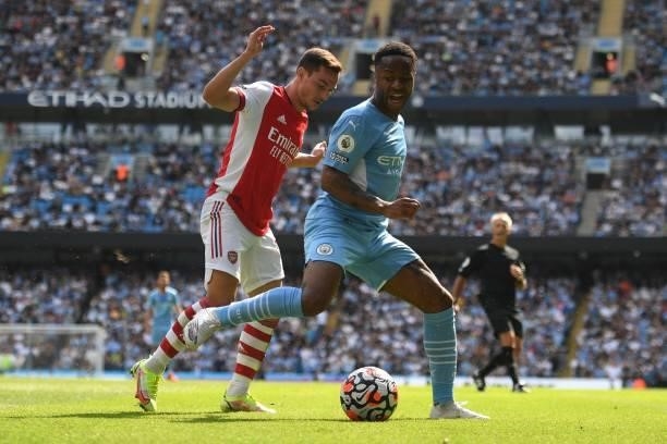 Arsenal's German-born Portuguese defender Cedric Soares vies with Manchester City's English midfielder Raheem Sterling during the English Premier...