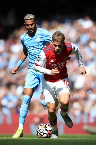 Emile Smith Rowe of Arsenal battles with Riyad Mahrez of Manchester City during the Premier League match between Manchester City and Arsenal at...