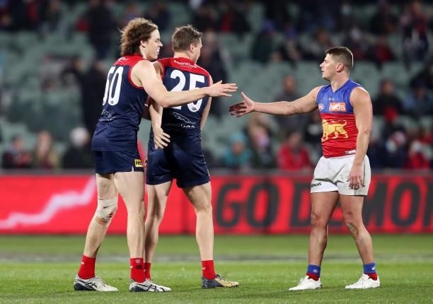 Dayne Zorko of the Lions shakes the hand of Ben Brown and Tom McDonald after the end of the match during the 2021 AFL First Qualifying Final match...