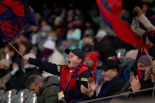 Demons fans celebrate a goal during the 2021 AFL First Qualifying Final match between the Melbourne Demons and the Brisbane Lions at Adelaide Oval on...