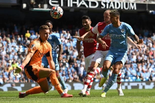 Manchester City's Portuguese defender Joao Cancelo has a shot on goal stopped by Arsenal's German goalkeeper Bernd Leno during the English Premier...