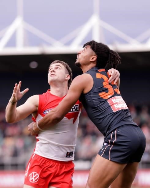 Tom Papley of the Swans and Connor Idun of the Giants compete for the ball during the 2021 AFL Second Elimination Final match between the Sydney...