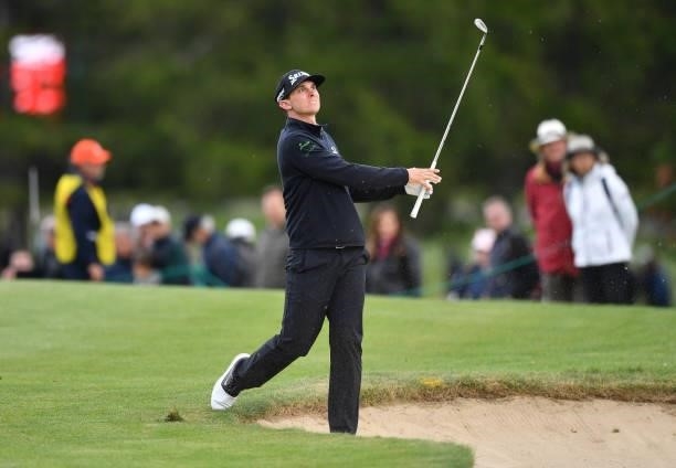 John Catlin of United States plays his second shot at the 17th hole with an awkward stance during Day Three of The Omega European Masters at...