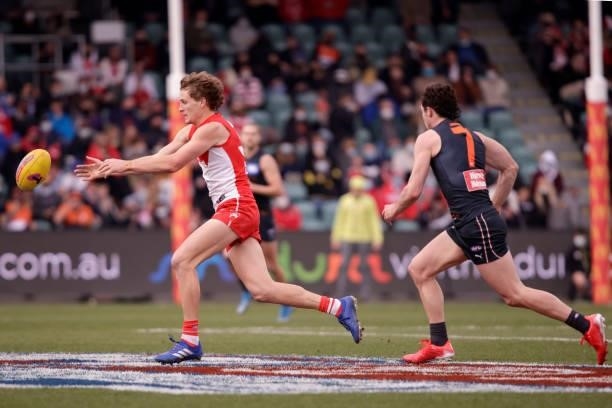 Jordan Dawson of the Swans is chased by Lachie Ash of the Giants during the 2021 AFL Second Elimination Final match between the Sydney Swans and the...