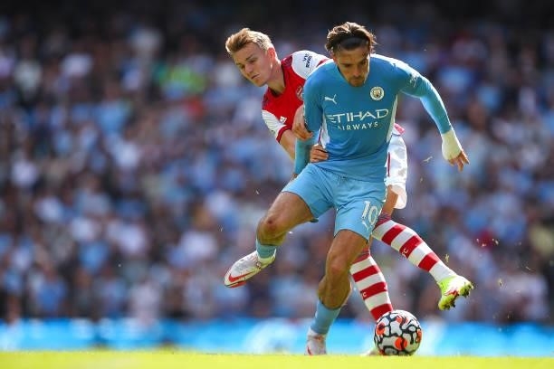 Martin Odegaard of Arsenal and Jack Grealish of Manchester City during the Premier League match between Manchester City and Arsenal at Etihad Stadium...