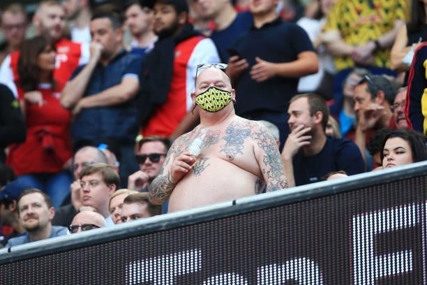 Bare-chested Arsenal fan wears a face mask during the Premier League match between Manchester City and Arsenal at Etihad Stadium on August 28, 2021...