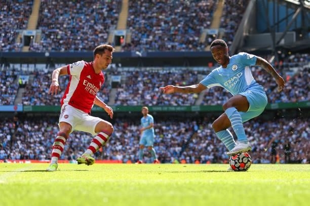 Cedric Soares of Arsenal and Raheem Sterling of Manchester City during the Premier League match between Manchester City and Arsenal at Etihad Stadium...