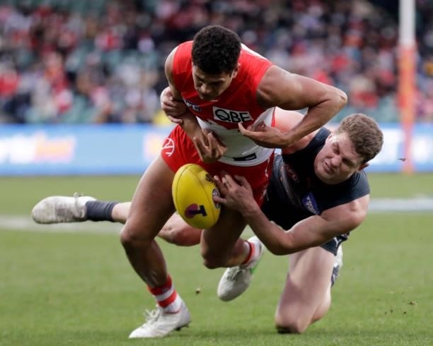 James Bell of the Swans is tackled by Jacob Hopper of the Giants during the 2021 AFL Second Elimination Final match between the Sydney Swans and the...