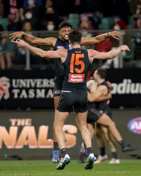 Connor Idun of the Giants and Sam Taylor of the Giants celebrates the win during the 2021 AFL Second Elimination Final match between the Sydney Swans...