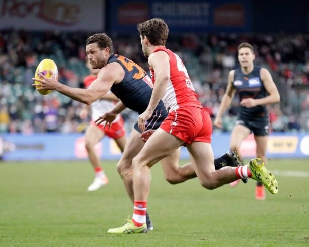Sam J. Reid of the Giants is chased by Robbie Fox of the Swans during the 2021 AFL Second Elimination Final match between the Sydney Swans and the...