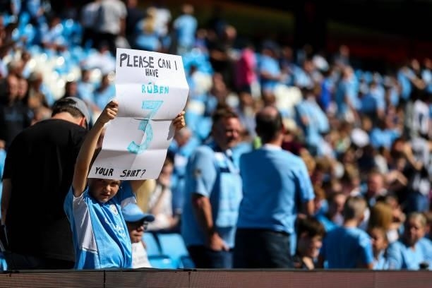 Young fan of Manchester City holds up a message for Ruben Dias of Manchester City during the Premier League match between Manchester City and Arsenal...
