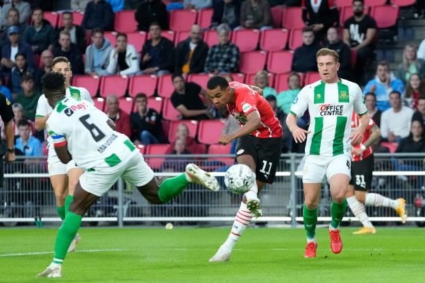 Cody Gakpo of PSV scores the first goal to make it 1-0, Wessel Dammers of FC Groningen, Azor Matusiwa of FC Groningen during the Dutch Eredivisie...