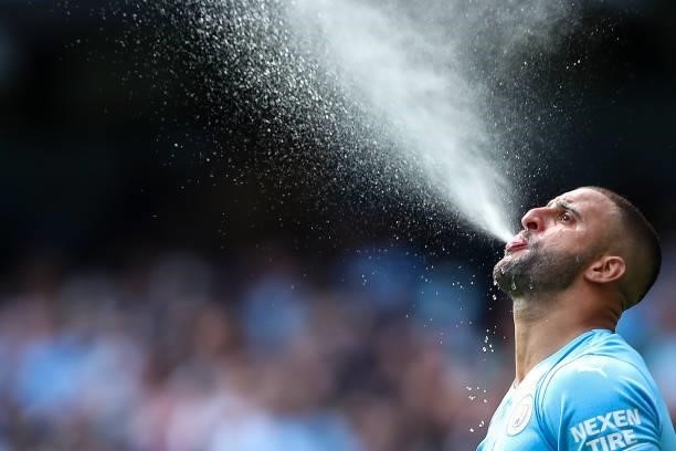 Kyle Walker of Manchester City sprays water out of his mouth during the Premier League match between Manchester City and Arsenal at Etihad Stadium on...
