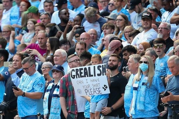 Young fan of Manchester City holds up a message for Jack Grealish of Manchester City during the Premier League match between Manchester City and...