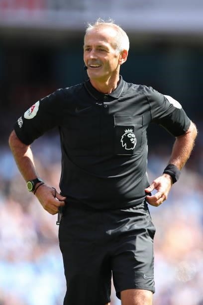 Referee Martin Atkinson during the Premier League match between Manchester City and Arsenal at Etihad Stadium on August 28, 2021 in Manchester,...