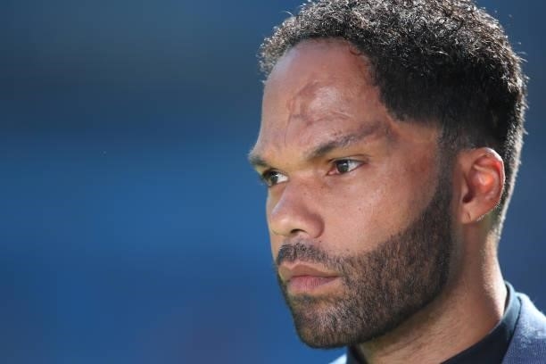 Joleon Lescott reporting for BT Sport during the Premier League match between Manchester City and Arsenal at Etihad Stadium on August 28, 2021 in...