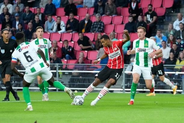 Cody Gakpo of PSV scores the first goal to make it 1-0, Wessel Dammers of FC Groningen during the Dutch Eredivisie match between PSV v FC Groningen...