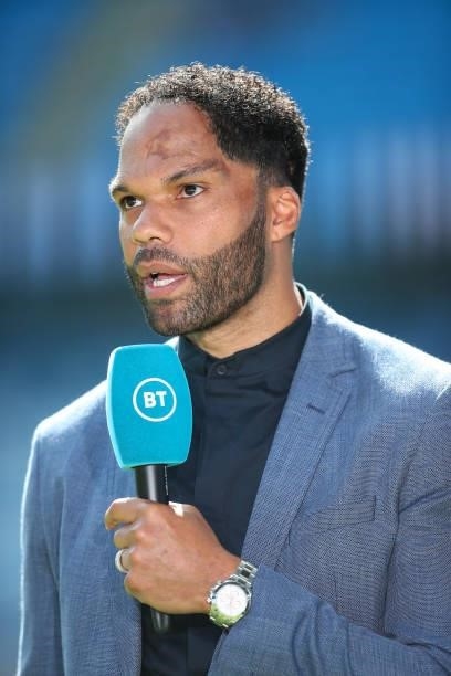 Joleon Lescott reporting for BT Sport during the Premier League match between Manchester City and Arsenal at Etihad Stadium on August 28, 2021 in...