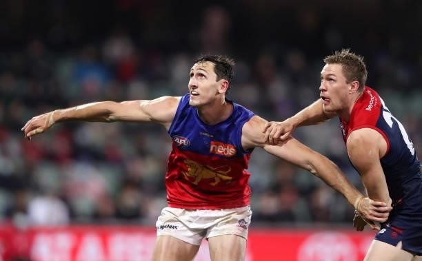 Oscar McInerney of the Lions and Tom McDonald of the Demons during the 2021 AFL First Qualifying Final match between the Melbourne Demons and the...
