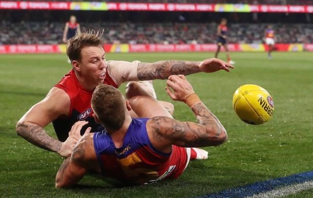 James Harmes of the Demons and Mitch Robinson of the Lions during the 2021 AFL First Qualifying Final match between the Melbourne Demons and the...