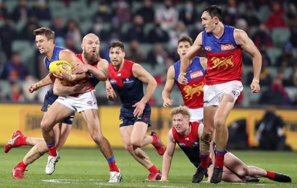Jarryd Lyons of the Lions is tackled by Max Gawn of the Demons during the 2021 AFL First Qualifying Final match between the Melbourne Demons and the...