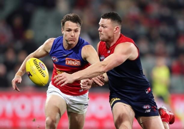 Lincoln McCarthy of the Lions and Steven May of the Demons during the 2021 AFL First Qualifying Final match between the Melbourne Demons and the...