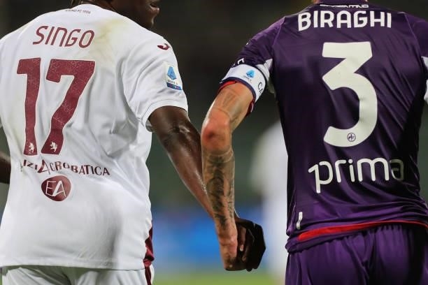 Cristiano Biraghi of ACF Fiorentina and Wilfred Stephane Singo of Torino FC fair play during the Serie A match between ACF Fiorentina and Torino FC...