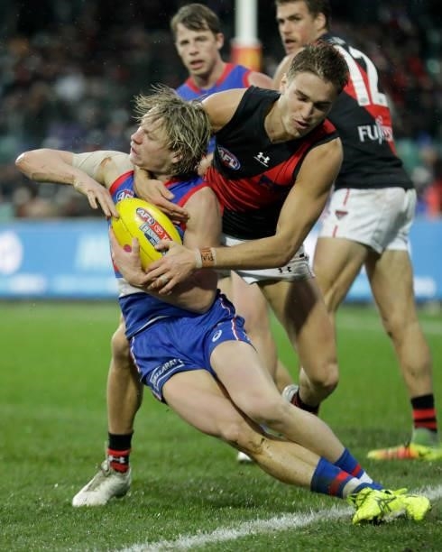 Cody Weightman of the Bulldogs is tackled by Matt Guelfi of the Bombers during the 2021 AFL First Elimination Final match between the Western...