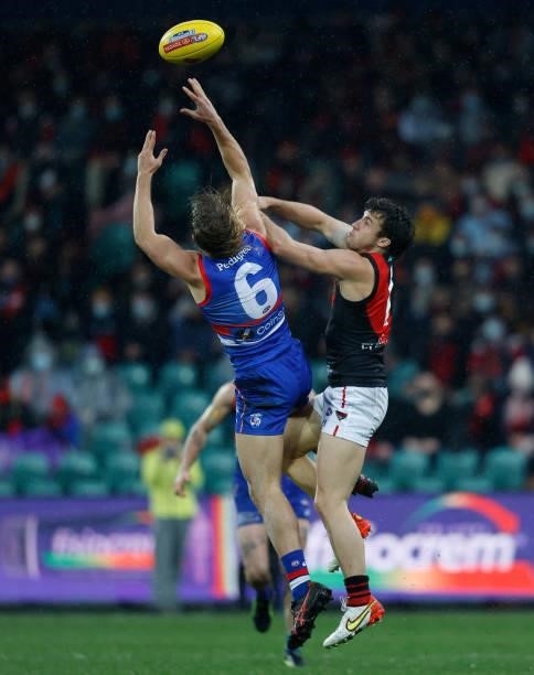 Bailey Smith of the Bulldogs and Andrew McGrath of the Bombers compete for the ball during the 2021 AFL First Elimination Final match between the...