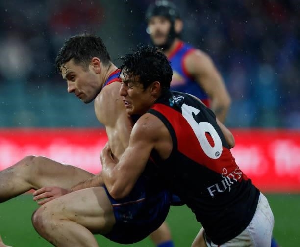 Jye Caldwell of the Bulldogs is tackled by Josh Dunkley of the Bombers during the 2021 AFL First Elimination Final match between the Western Bulldogs...