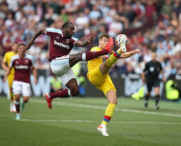 Michail Antonio of West Ham United challenges Joachim Andersen of Crystal Palace for the ball during the Premier League match between West Ham United...