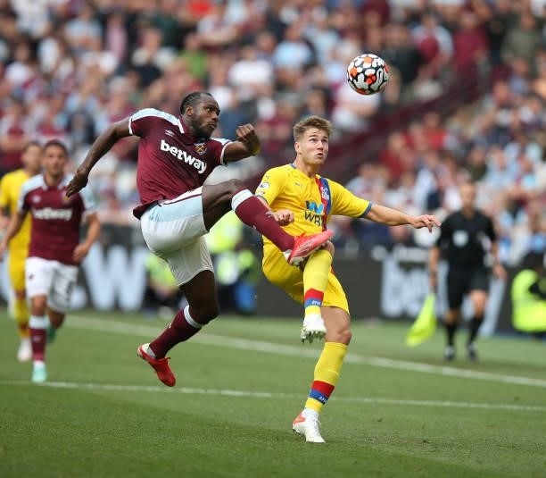 Michail Antonio of West Ham United challenges Joachim Andersen of Crystal Palace for the ball during the Premier League match between West Ham United...