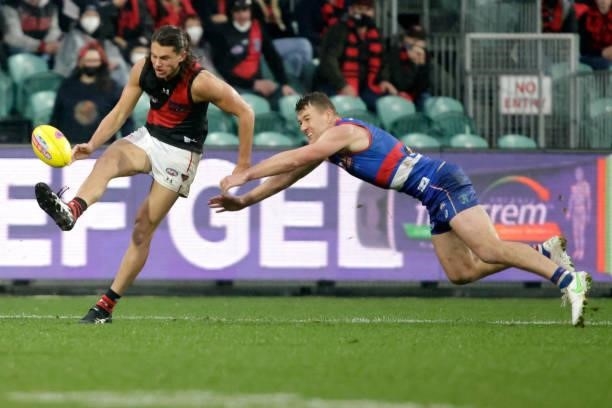 Archie Perkins of the Bombers kicks the ball during the 2021 AFL First Elimination Final match between the Western Bulldogs and the Essendon Bombers...