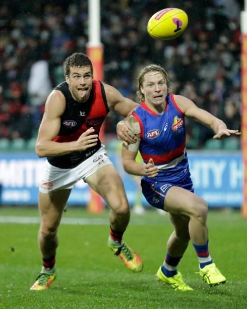 Tom Cutler of the Bombers and Cody Weightman of the Bulldogs compete for the ball during the 2021 AFL First Elimination Final match between the...