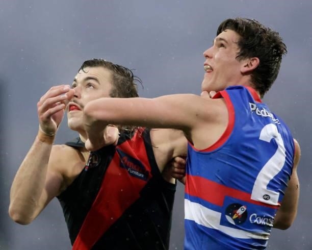 Lewis Young of the Bulldogs and Sam Draper of the Bombers compete in a ruck contest during the 2021 AFL First Elimination Final match between the...