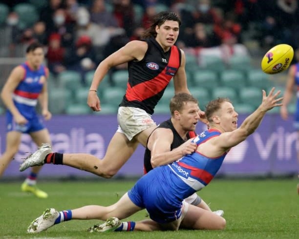 Lachie Hunter of the Bulldogs and Jake Stringer of the Bombers compete for the ball during the 2021 AFL First Elimination Final match between the...
