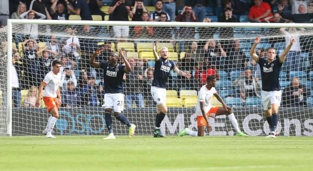 Millwall's Benik Afobe after going close and Scott Malone and Matt Smith appeal for a corner during the Sky Bet Championship match between Millwall...
