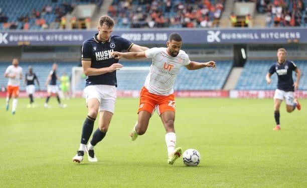 Blackpool's CJ Hamilton and Millwall's Jake Cooper during the Sky Bet Championship match between Millwall and Blackpool at The Den on August 28, 2021...