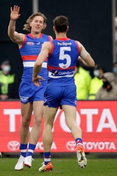 Aaron Naughton of the Bulldogs celebrates a goal with Josh Dunkley of the Bulldogs during the 2021 AFL First Elimination Final match between the...