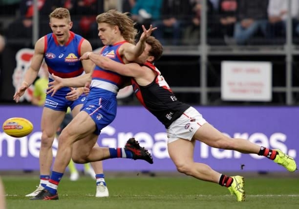 Bailey Smith of the Bulldogs is tackled by Will Snelling of the Bombers during the 2021 AFL First Elimination Final match between the Western...