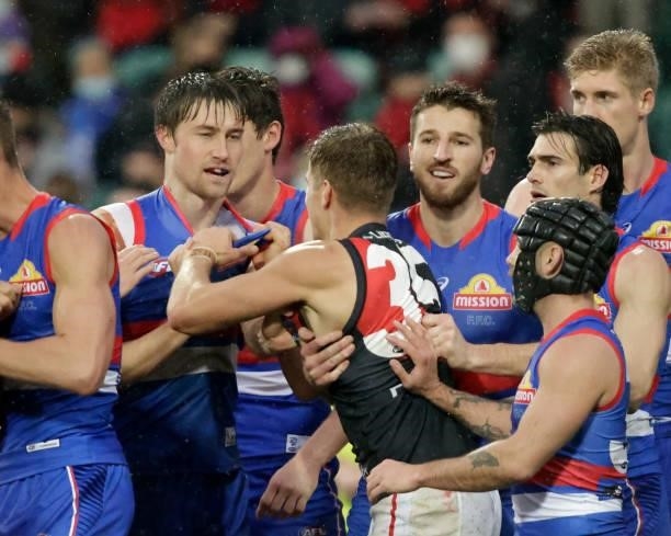 Ryan Gardner of the Bulldogs argues with Matt Guelfi during the 2021 AFL First Elimination Final match between the Western Bulldogs and the Essendon...