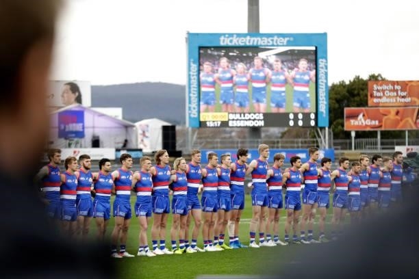 The Western Bulldogs line up for the National Anthem during the 2021 AFL First Elimination Final match between the Western Bulldogs and the Essendon...
