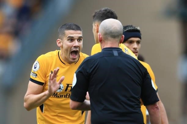 Conor Coady of Wolverhampton Wanderers pleads with referee Mike Dean during the Premier League match between Wolverhampton Wanderers and Manchester...