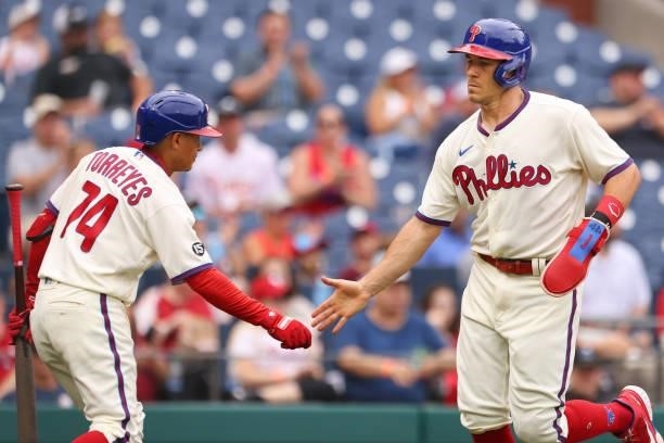 Realmuto of the Philadelphia Phillies is congratulated by Ronald Torreyes after scoring on a single by Andrew McCutchen against the Arizona...