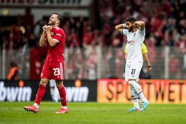 Niko Gießelmann of Union and Keanan Bennetts of Borussia Moenchengladbach react after the Bundesliga match between 1.FC Union Berlin and Borussia...