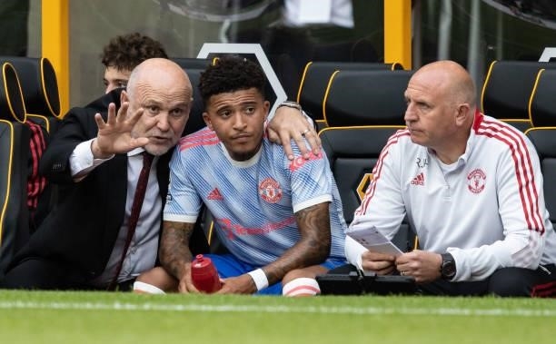 Manchester United's assistant manager Mike Phelan chats to Jadon Sancho after his substitution during the Premier League match between Wolverhampton...