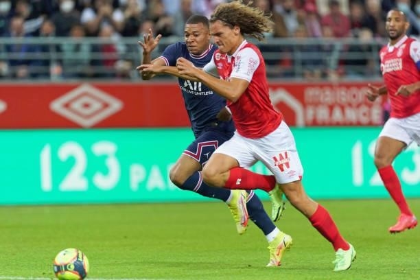 Kylian Mbappe of PSG competes for the ball with Wout Faes of Reims during the Ligue 1 Uber Eats match between Reims and Paris Saint Germain at Stade...