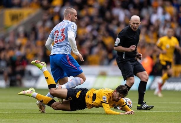 Wolverhampton Wanderers' Trincao goes to ground after a challenge from Manchester United's Luke Shaw during the Premier League match between...
