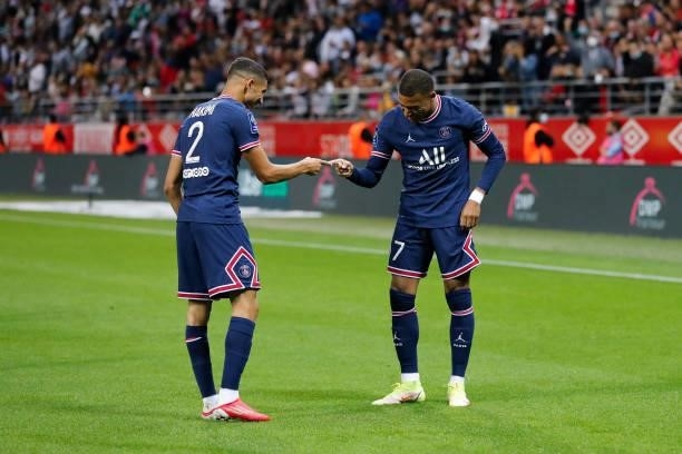 Kylian Mbappe of Paris Saint-Germain celebrates his goal Achraf Hakimi of Paris Saint-Germain during the Ligue 1 Uber Eats match between Reims and...