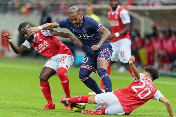 Neymar Junior of Paris competes for the ball with Cassama Moreto and Ilan Kebbal of Reims during the Ligue 1 Uber Eats match between Reims and Paris...